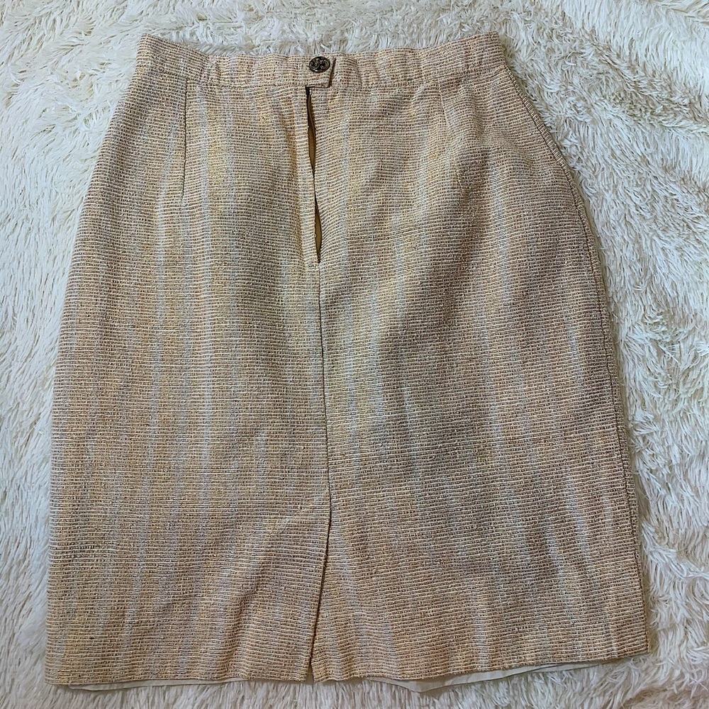 White and gold knee length skirt.